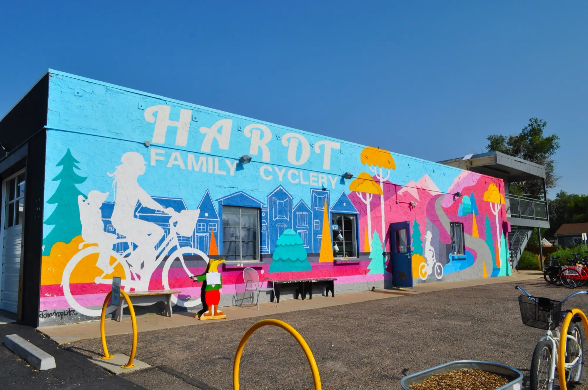 The Hardt Family Cyclery storefront mural in Aurora's Central Park neighborhood